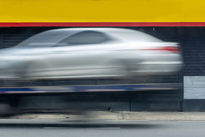 Blurred motion of car on street