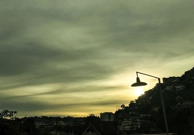 Low angle view of buildings against cloudy sky