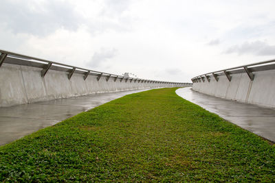 View of bridge over calm sea against sky