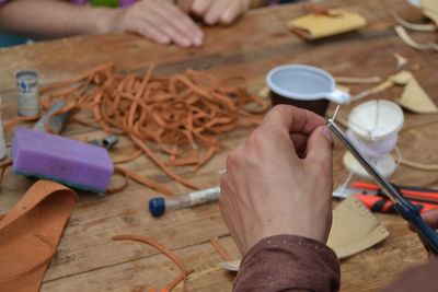 Cropped hand of man working on workbench