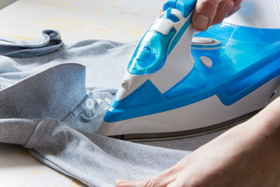 Close-up of woman ironing clothes