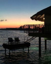 Silhouette pier on sea against sky during sunset