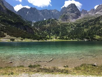 Scenic view of lake and mountains against sky