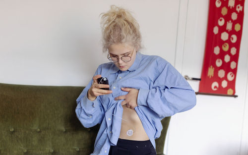 Young woman using insulin pump