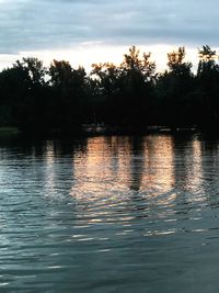 Scenic view of lake against sky at sunset