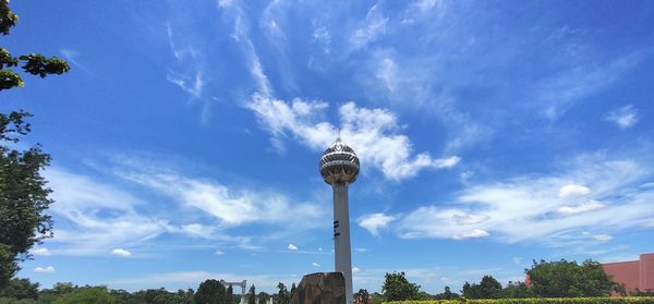 Low angle view of tower against cloudy sky