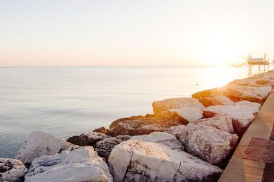 Scenic view of sea against clear sky during sunrise