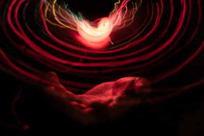 Close-up of light painting against black background