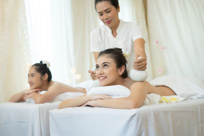 Young woman receiving massage in spa