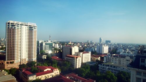 High angle view of buildings against clear blue sky