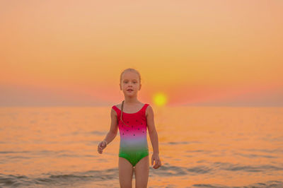 Portrait of boy on beach during sunset