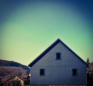 Low angle view of built structure against clear blue sky