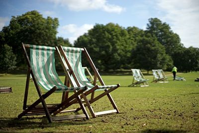 Two free sunbathing stools in the city park on the grass