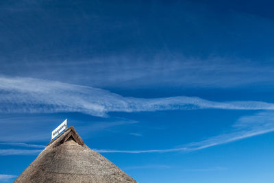 Scenic view of snow covered mountain against blue sky