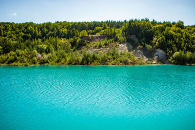 Scenic view of swimming pool by sea against sky
