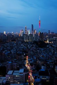 Illuminated buildings in city against sky