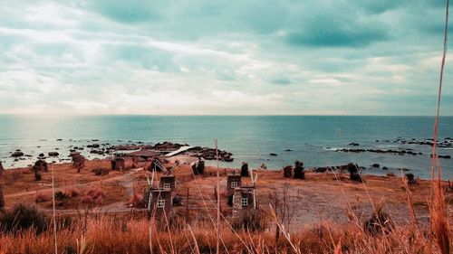 Abandoned building by sea against sky