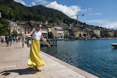 Woman standing on mountain against sky