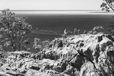 High angle view of rocks by sea against sky