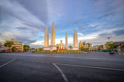 Road amidst buildings against sky