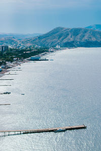Scenic view of sea by city against sky