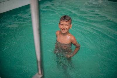 Portrait of shirtless boy in swimming pool