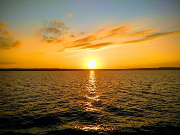 Scenic view of sea against romantic sky at sunset