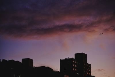 Silhouette buildings against sky during sunset