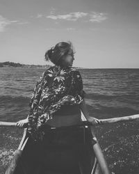 Rear view of woman looking at sea against sky