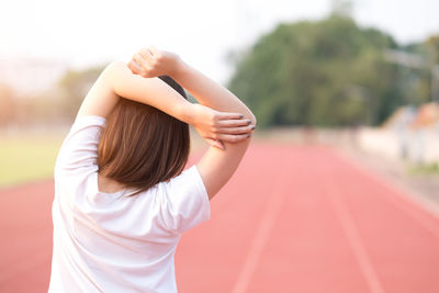 Woman stretching on running track