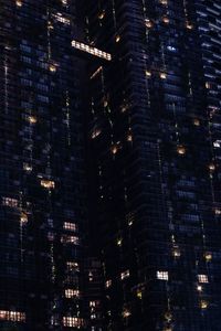 Low angle view of illuminated buildings in city at night