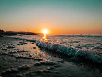 Scenic view of sea against clear sky during sunset