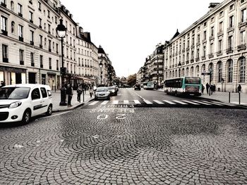 City street and buildings against sky