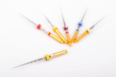 Close-up of colored pencils over white background