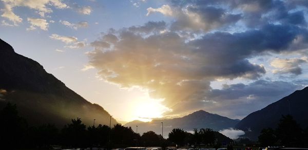 Scenic view of silhouette mountains against sky at sunset