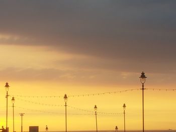 Low angle view of silhouette street light against sky during sunset