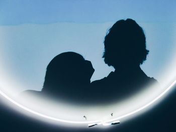 Rear view of silhouette couple against clear sky