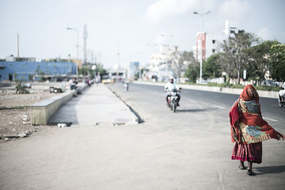 People on road against the sky