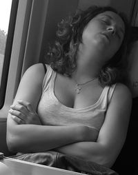 Young woman napping in train