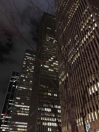 Low angle view of modern building against sky at night