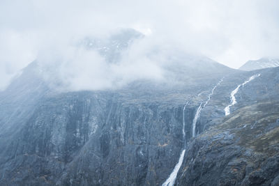 Mountaintop in norway with cloud cover and stigfossen waterfall.