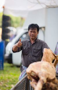 Portrait of man gesturing thumbs up