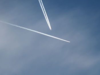 Low angle view of airplane flying against sky