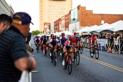 People riding bicycle on road in city