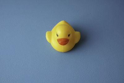 Close-up of yellow toy over blue background