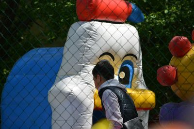 Rear view of boy standing outdoors