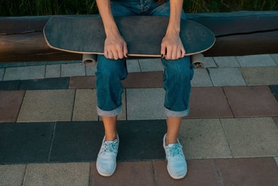 Low section of woman sitting on seat