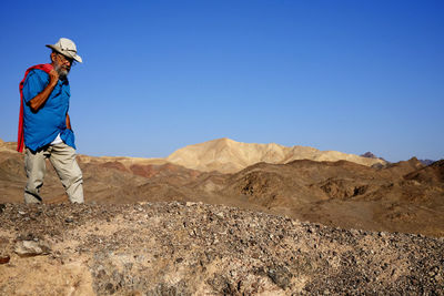 Senior man walking in the desert 