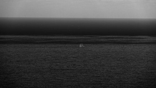 Man sailing on sea against clear sky