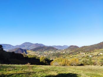 Scenic view of mountains against clear blue sky